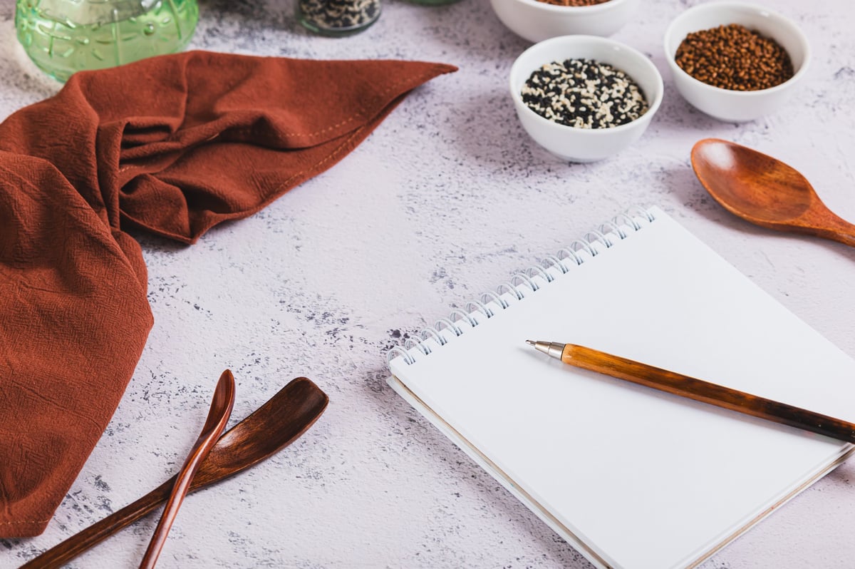 Concept of writing grocery lists for cooking on the table